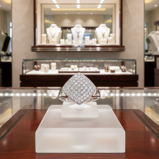 Diamond ring on display in a jewelry store with other jewelry in the background