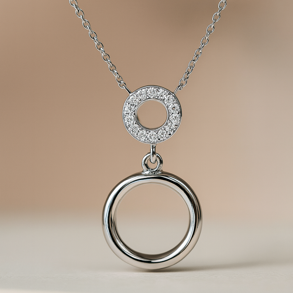 Silver necklace with two interlocking rings on a beige background
