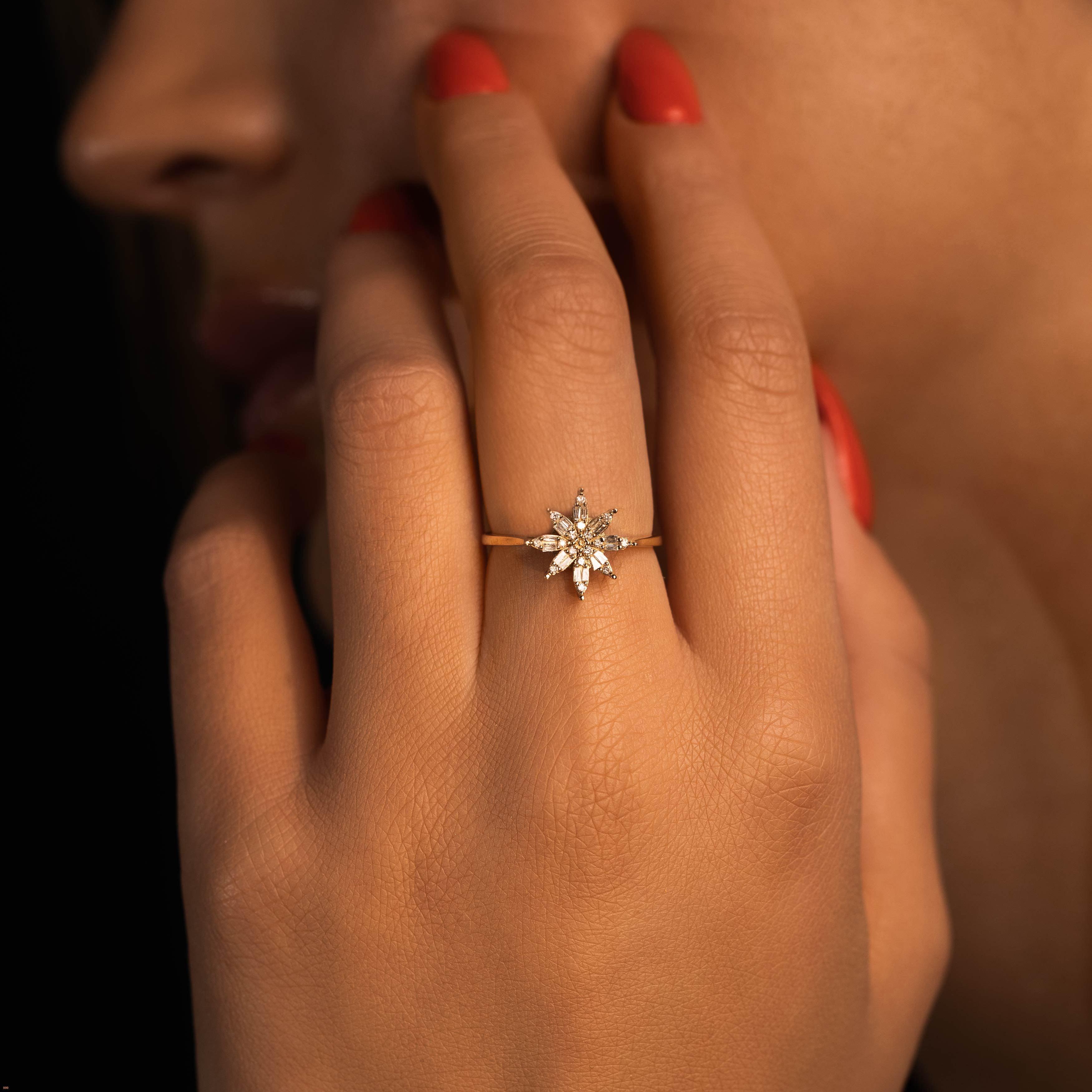 תקריב של יד אישה עונדת טבעת אירוסין מנצנצת עם הדגשים של יהלומים.